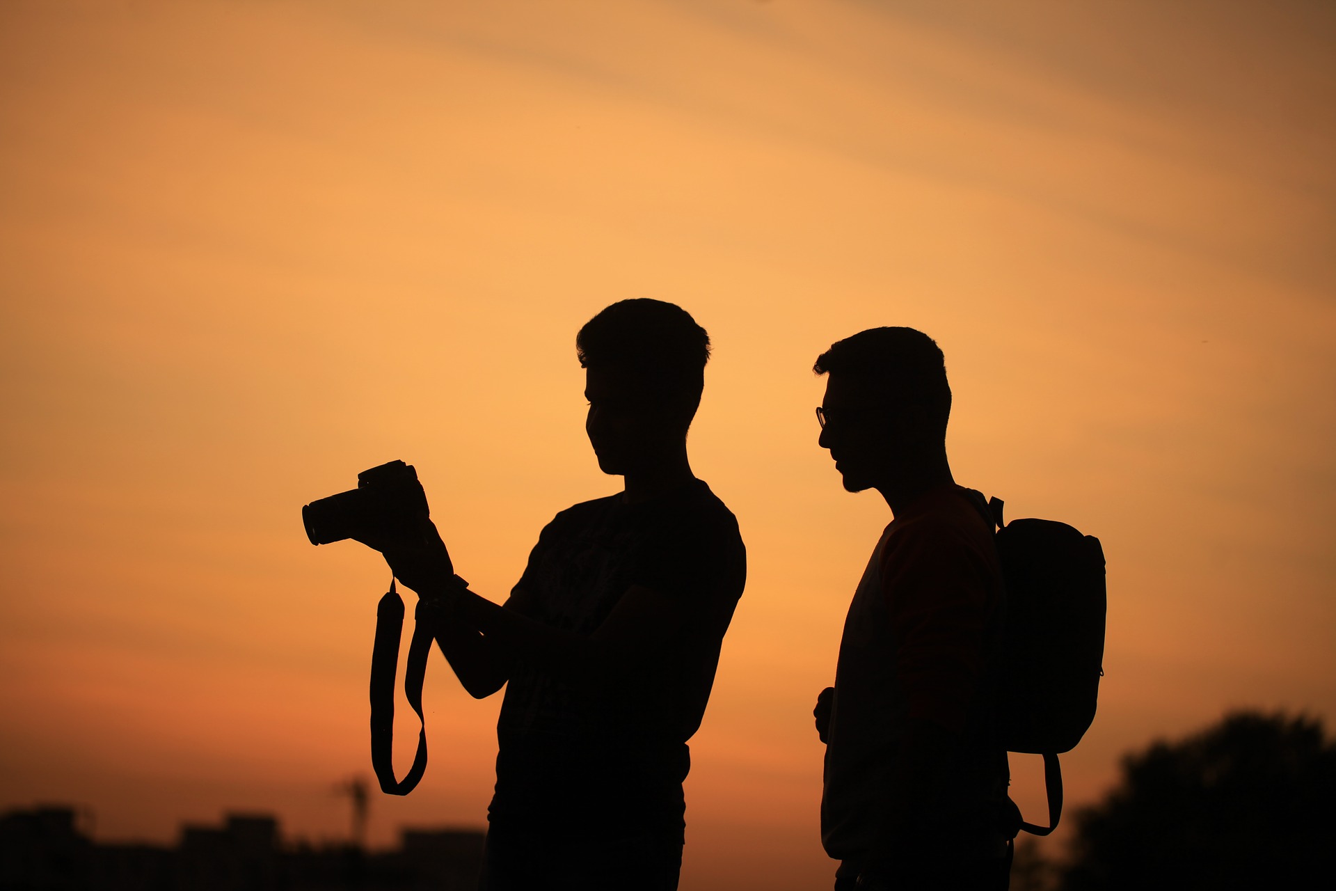 silhouette of two videographers