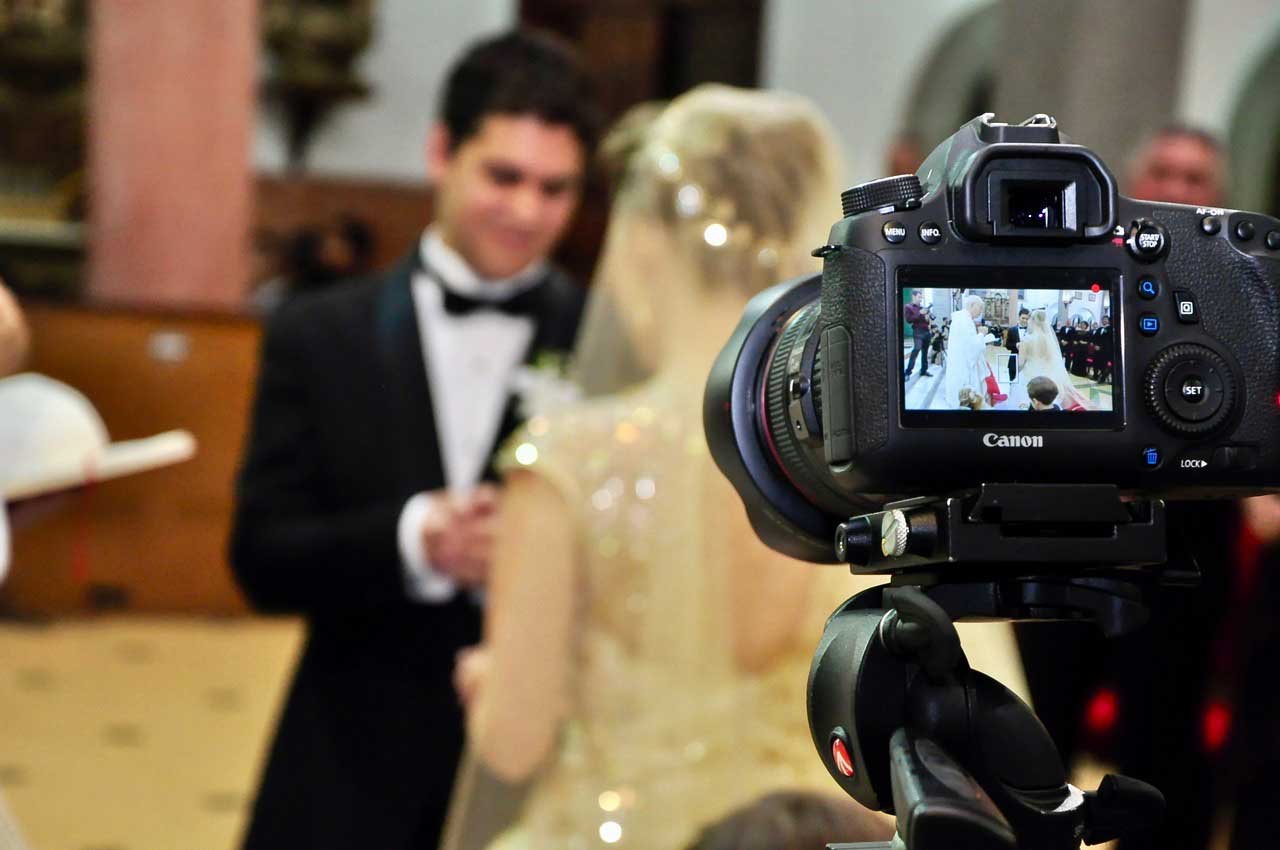 camera filmning a bride and groom 