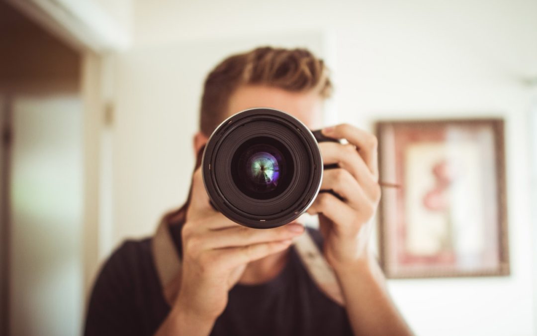 man taking a selfie with a canon video camera
