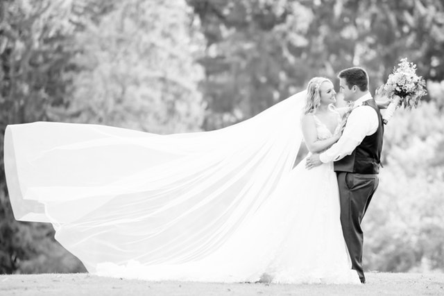 bride and groom in white and black