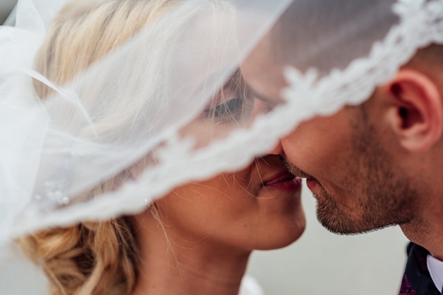 closeup of bride and groom kissing