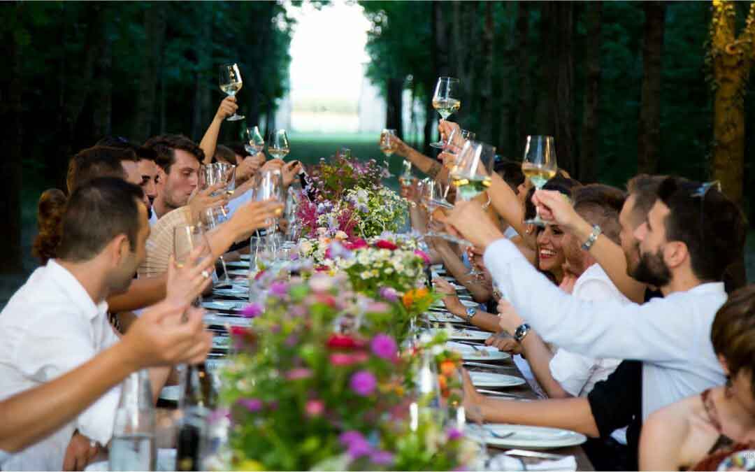 people toasting sitting at a table at a wedding