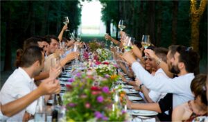 people toasting sitting at a table at a wedding