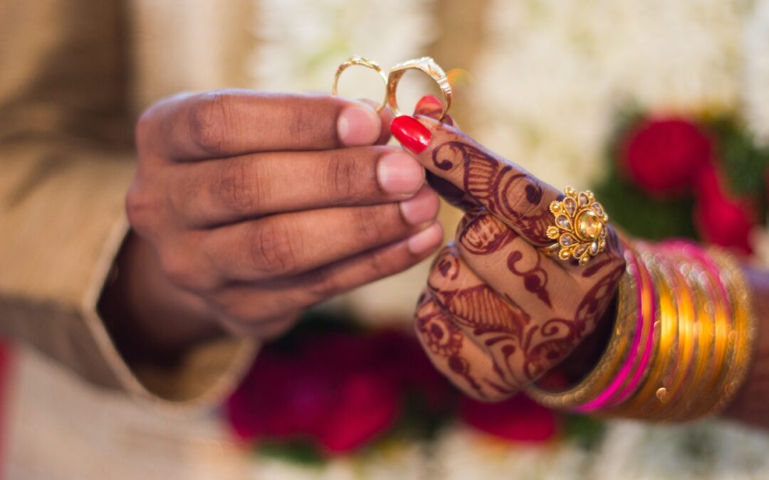 Indian wedding couple holding rings