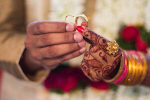 Indian wedding couple holding rings