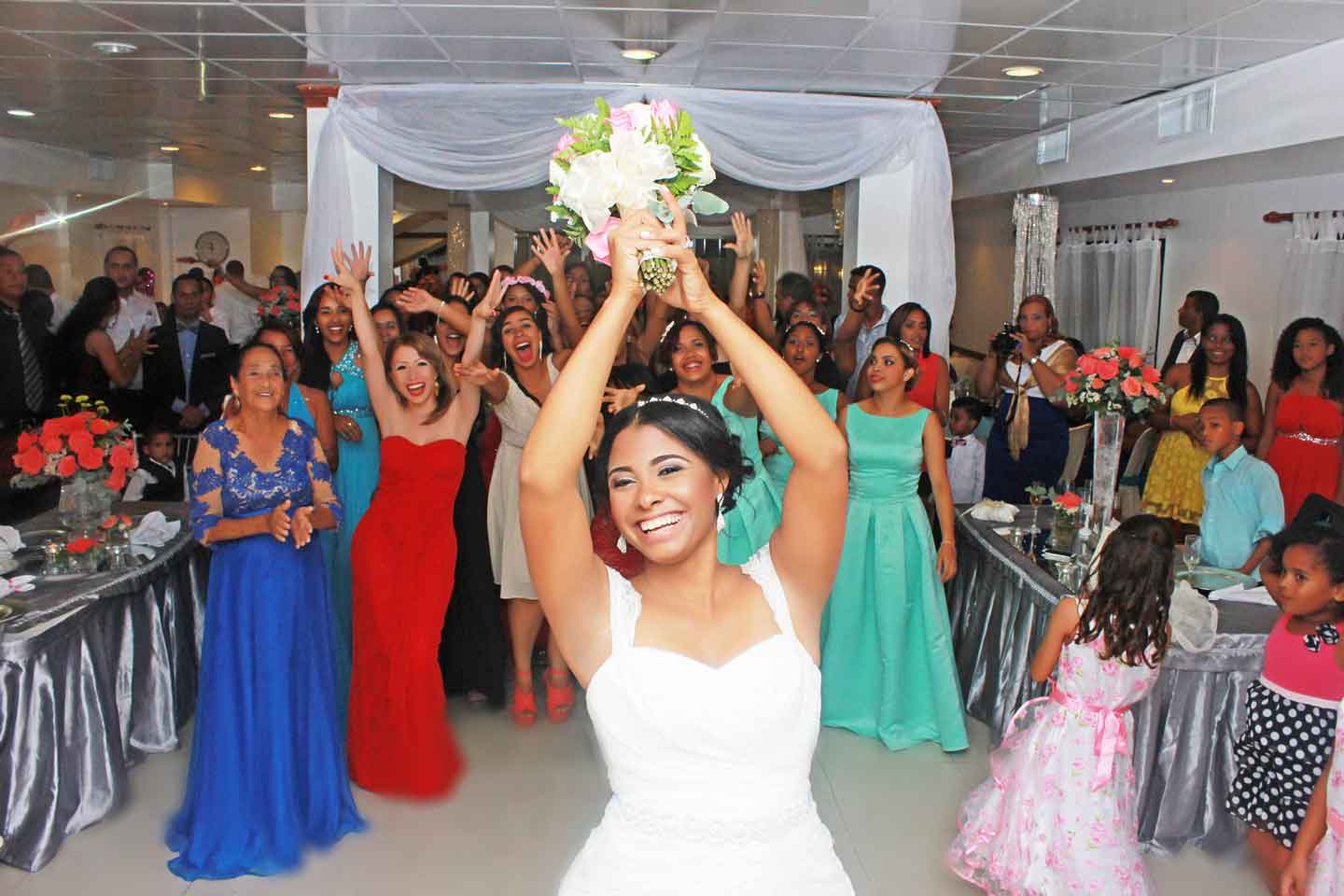 bride tossing the bouquet at wedding