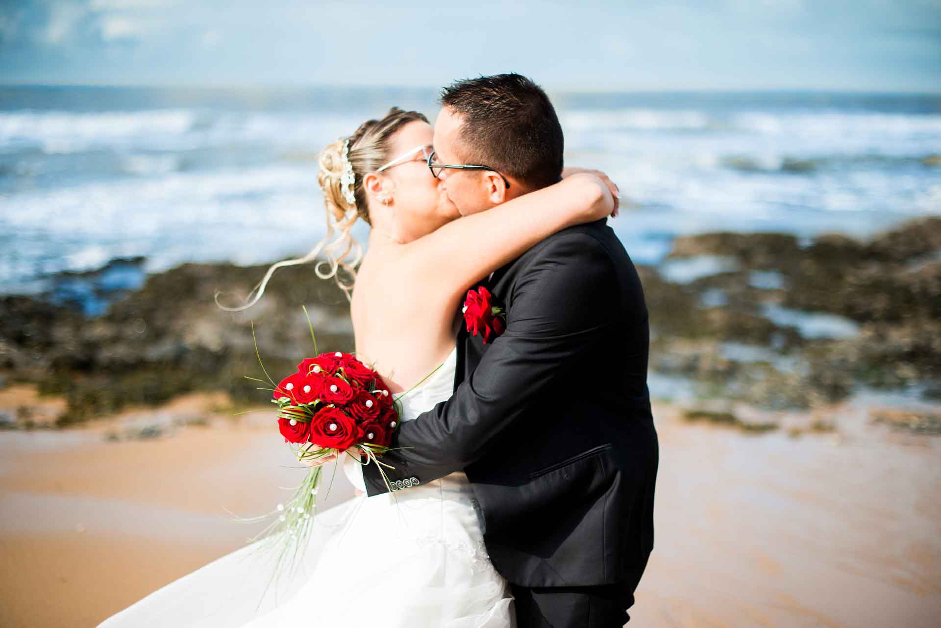 wedding couple kissing at beach