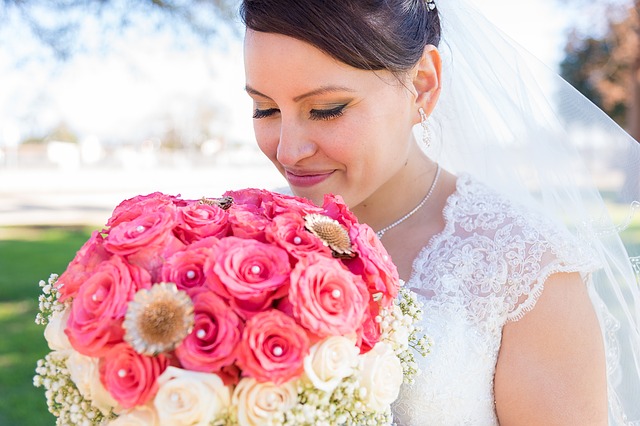 bride holding red bouquet