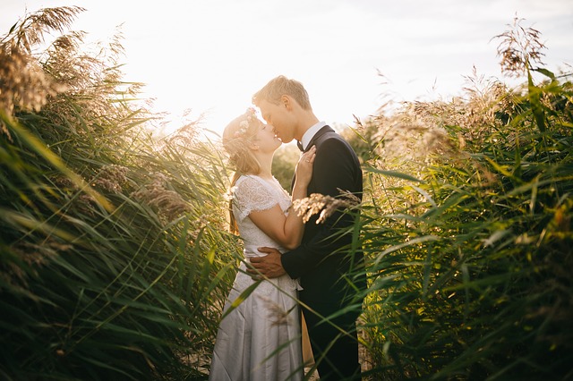 bride and groom in the middle of corn field