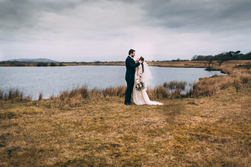 bride and groom at lake