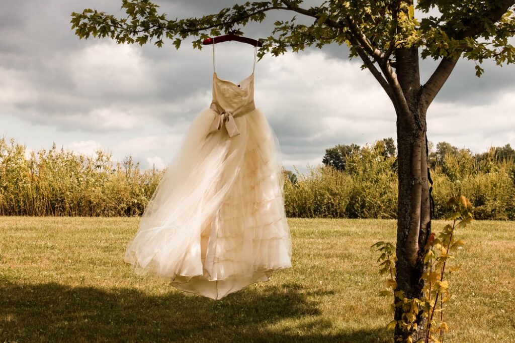 wedding dress hanging on tree