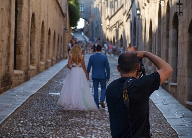 photographer taking pictures of bride and groom 