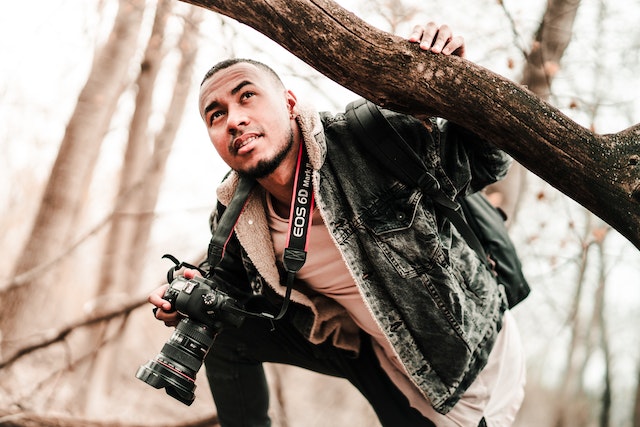 photographer with camera in the woods